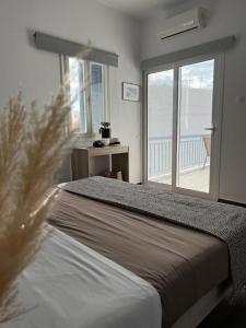 a bedroom with a bed with a view of the ocean at Fatolitis Studios in Masouri