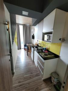 a kitchen with white cabinets and a counter top at departamento salta argentina in Salta