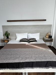 a bedroom with a large bed with two pillows at Fatolitis Studios in Masouri