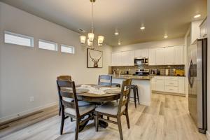 a dining room with a table and chairs in a kitchen at Hygee House Brand New Construction near Ford Idaho Center and I-84! Plush and lavish furniture, warm tones to off-set the new stainless appliances, play PingPong in the garage or basketball at the neighborhood park in Meridian