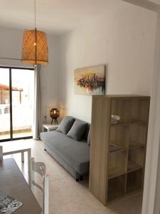 a living room with a couch and a table at The Olive Garden Apartments in Gouves