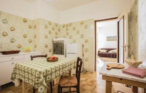 a kitchen with a table and a refrigerator and a table and chairs at La Quiete in Casarza Ligure +7 photos