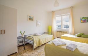 a room with two beds and a window at La Quiete in Casarza Ligure