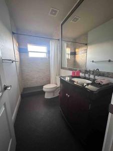 a bathroom with a sink and a toilet and a mirror at Ft Lauderdale Jewel in Fort Lauderdale +22 photos