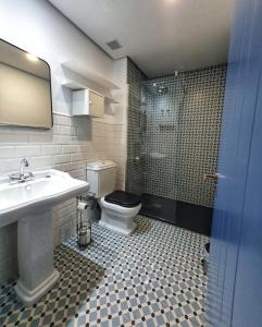 a bathroom with a toilet and a sink and a shower at Casa Albarrana in Talavera de la Reina +29 photos