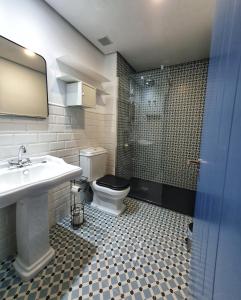 a bathroom with a toilet and a sink and a shower at Casa Albarrana in Talavera de la Reina