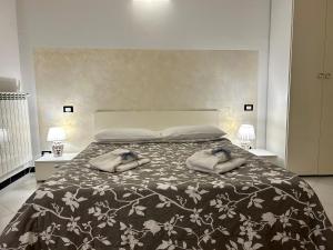 a bedroom with a bed with two pillows on it at Ohana by Casimiro in Trapani