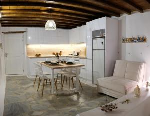 a kitchen and dining room with a table and chairs at Our Beautiful House in Ornos, Mykonos in Ornos