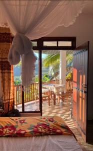 a bedroom with a bed and a view of a patio at Saddle Cottage in Ella