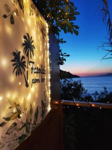 a sign for a resort with a view of the ocean at Fatolitis Studios in Masouri
