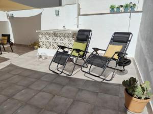 a group of four chairs sitting on a patio at Céntrico apartamento con terraza y WIFI in Ronda