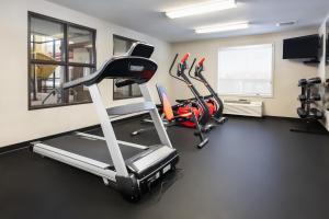 a gym with several cardio machines in a room at Home Inn and Suites Lloydminster in Lloydminster