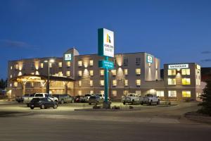 a large building with cars parked in a parking lot at Home Inn and Suites Lloydminster in Lloydminster