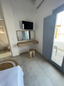 A television and/or entertainment centre at Sohoros Luxury Suites
