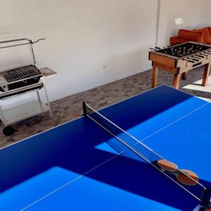 a blue ping pong table in a room at Perto do Mar, Alojamento Local - Espaço T2 privativo in Vagos