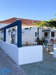 une maison blanche avec une clôture devant dans l'établissement Perto do Mar, Alojamento Local - Espaço T2 privativo, à Vagos