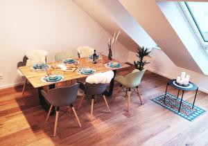 comedor con mesa de madera y sillas en Seezeit - gemütliche Ferienwohnung, Tiefgarage, Cospudener See, en Markkleeberg