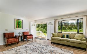 a living room with a couch and chairs and a table at Hawaiian Plantation Style Home in Mountain View in Mountain View
