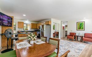 a kitchen and dining room with a table and chairs at Hawaiian Plantation Style Home in Mountain View in Mountain View