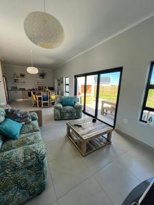 a living room with a couch and a table at Casa Felice in Langebaan