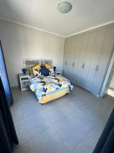 1 dormitorio con 1 cama y suelo de baldosa en Casa Felice, en Langebaan