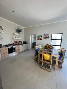 a kitchen and living room with a table and chairs at Casa Felice in Langebaan