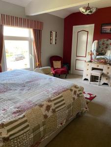 a bedroom with a large bed and a window at Killerby Cottage Farm in Scarborough