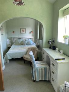 une chambre avec un lit et un bureau avec une chaise dans l'établissement Killerby Cottage Farm, à Scarborough