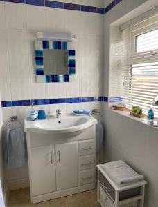 a bathroom with a sink and a mirror at Killerby Cottage Farm in Scarborough