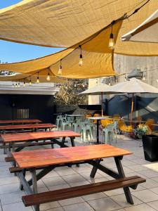 a group of picnic tables with umbrellas and chairs at Hostel Boutique Merced 88 in Santiago