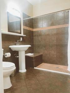 a bathroom with a sink and a toilet at Pacific Blue Inn in Santa Cruz
