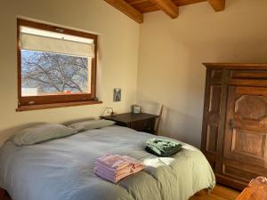 a bedroom with a bed with two towels on it at Chalet Gorret in Torgnon