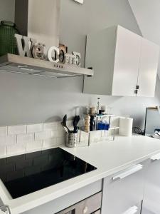 a kitchen with white cabinets and a counter top at Escapade marine in Deauville