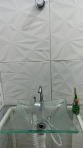 um lavatório numa casa de banho com uma tampa de vidro em Pousada Santo Amaro em Santo Amaro