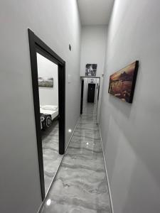 a hallway with a mirror and a room with a bed at FORIA HOUSE VALENTiNO in Naples