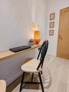 a desk with a chair and a laptop on it at Trafalgar House Apartment in Beckenham