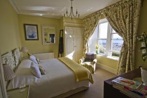 a hotel room with a bed and a window at Loch Gorm House in Bruichladdich