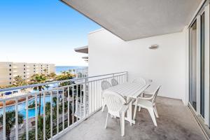 a balcony with a table and chairs and a view of the ocean at Waterscape B624 in Fort Walton Beach