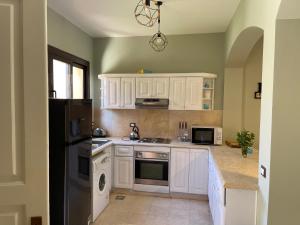 A kitchen or kitchenette at El gouna South Marina Townhouse Apartment 3 bedrooms