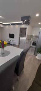 a kitchen with a table and chairs in a room at Apartman Amor Trebinje in Trebinje