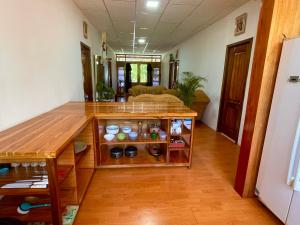 a room with a wooden table with a shelf at La Casa De Eros in Ayampe