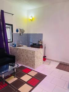 a kitchen with a sink and a counter in a room at Residence SVET in Kribi