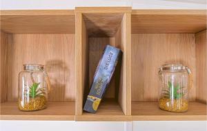 two glass jars with plants in them on a wooden shelf at Wildkraeuterweg 1 in Gottsdorf