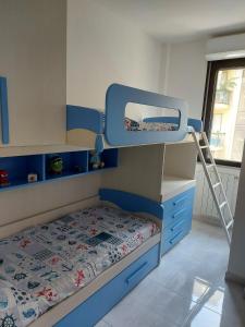 a small bedroom with a bunk bed and a ladder at Casa Alghero Lido in Alghero