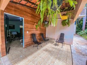 a group of chairs sitting on a patio at Espaço Monjolo in Barra do Garças +51 photos