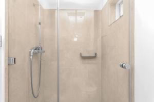 W łazience znajduje się prysznic ze szklanymi drzwiami. w obiekcie Studio Apartment with Ocean View w Reykjavík