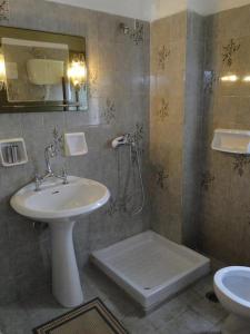 ミラトスにあるParadise Innのバスルーム(洗面台、トイレ、鏡付)