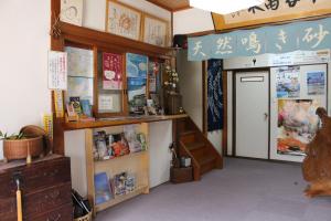 a room with writing on the wall and a door at Minshuku Oe in Kyotango