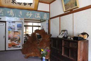 a room with a large wooden tree in the corner of a room at Minshuku Oe in Kyotango