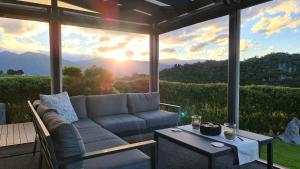 a living room with a couch and a table at Rocky Ridge Cottage in Takaka